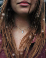 14k gold tag with initial necklace on model
