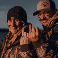 Couple wearing personalized duck band wedding rings