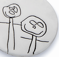 Close up of engraved kids drawing necklace on sterling silver pendant