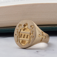 Men’s gold signet ring with engraved family crest and side details