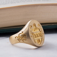 Men’s 14K gold family crest signet ring with side engraving detail